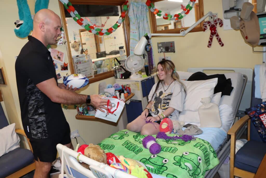 Exeter Chiefs players deliver presents to children at the Royal Devon and Exeter Hospital