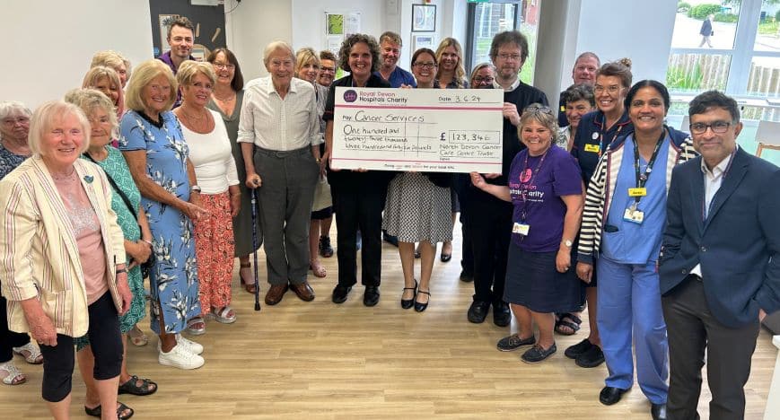 NDCCCT chairman James Bonetta and volunteers present the charity’s final fundraising cheque to Carolyn Mills, Chief Nursing Officer at Royal Devon University Healthcare NHS Foundation Trust.