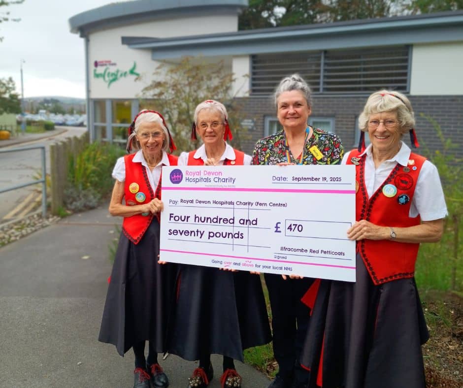 Janet Ellis and members of The Ilfracombe Red Petticoats present the groups’ fundraising cheque to Fern Centre manager Holly Conway