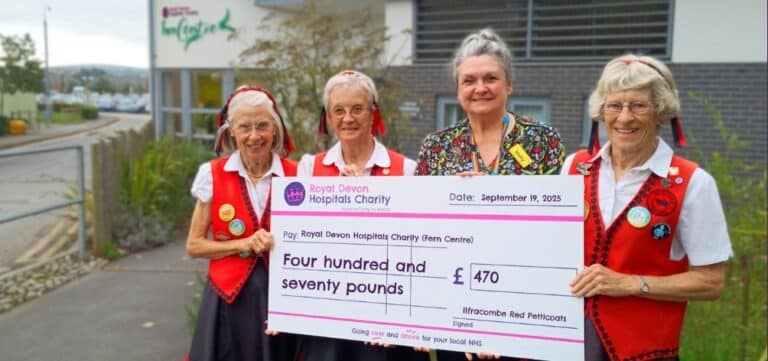 Janet Ellis and members of The Ilfracombe Red Petticoats present the groups’ fundraising cheque to Fern Centre manager Holly Conway