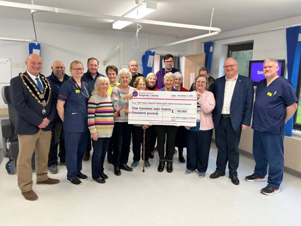 South Molton League of Friends members celebrate the completion of the new wet rooms on the Hugh Squier Ward with staff, North Devon MP Ian Roome, North Devon MP Mayor of South Molton Paul Henderson, and representatives from Royal Devon Hospitals Charity and contractors Arque.
