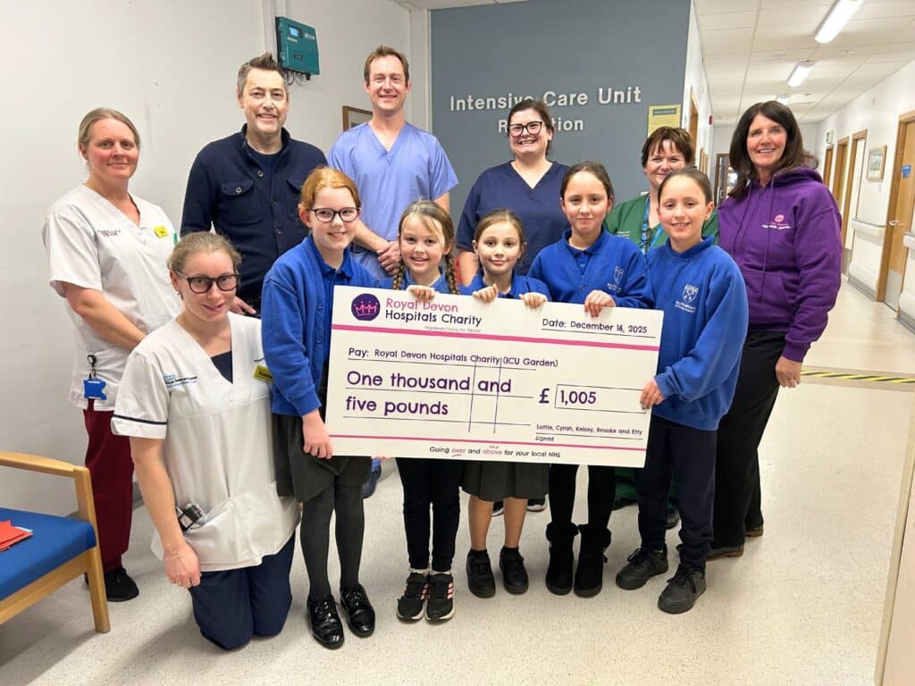 Lottie and friends Cyrah, Kelsey, Brooke and Etty, pictured with Lottie’s dad Matt and Debbie Allen from Royal Devon Hospitals Charity, present their fundraising cheque to ICU staff.
