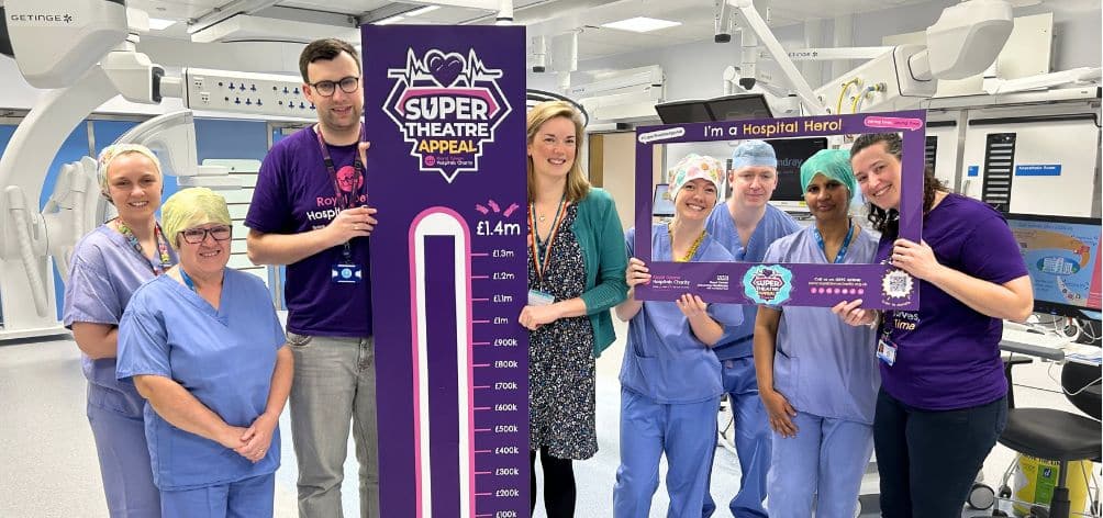 Theatres and charity staff celebrate hitting the £1.4m fundraising target in the new Super Theatre at the Royal Devon and Exeter Hospital.