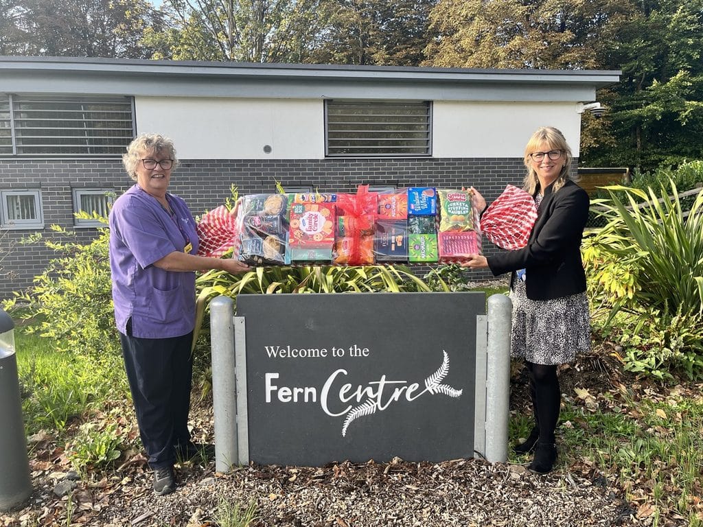 Tara and Adel outside the Fern Centre with the giant Christmas cracker hamper prize
