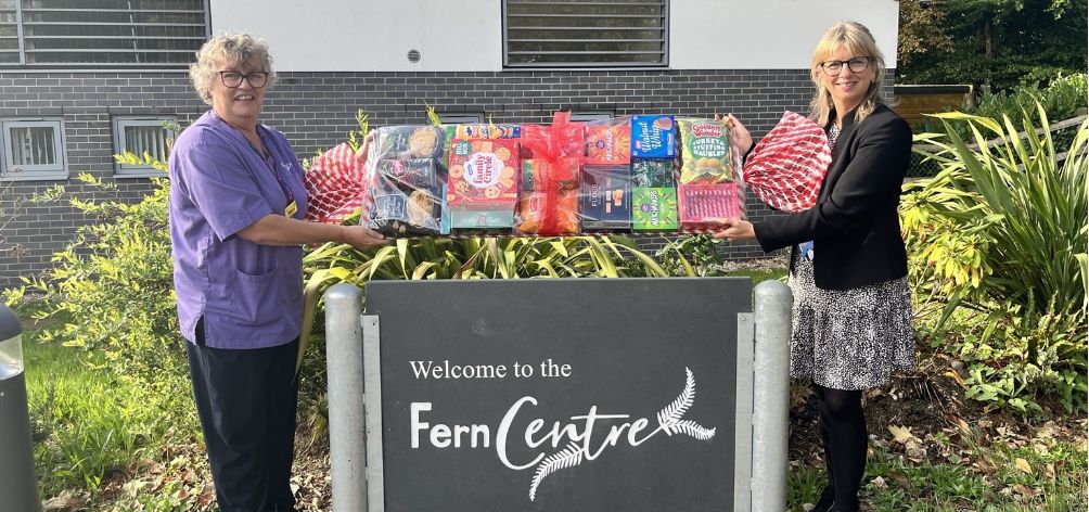 Tara and Adel outside the Fern Centre with the giant Christmas cracker hamper prize
